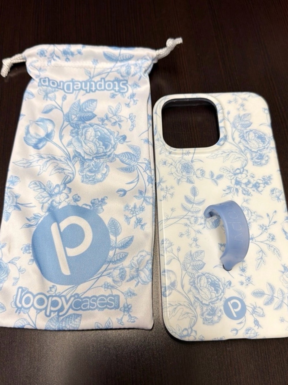 Lightly Used Loopy IPhone 15 Promax case in blue toile.